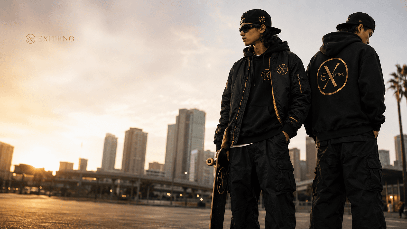 EXITIING — two figures in black streetwear walking through gold-lit city at sunset